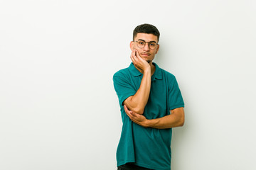 Young hispanic man who is bored, fatigued and need a relax day.