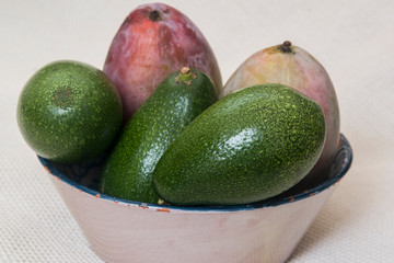 natural avocados and mangoes on white background