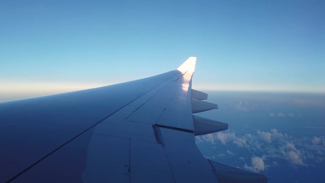 Large Jet Wing Flying at 40,000 Feet, Window View With Copy Space