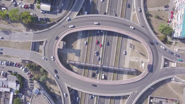 Spinning aerial shot of Roundabout and highway with traffic and cars