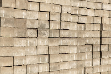 Old concrete brick stacked in a row. Concrete for construction