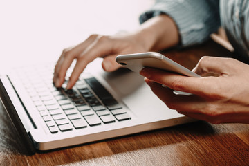 Woman working at home office hand on keyboard close up