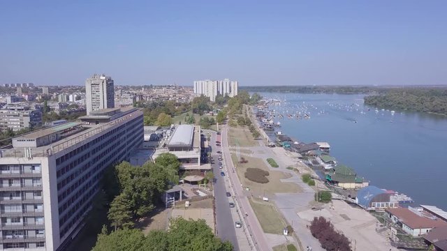 Long slow fly over Zemun kej and Danube river in summer day