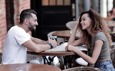 Beautiful loving couple sitting in a cafe enjoying in coffee