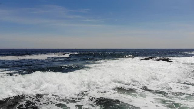 aerial footage of waves crashing along the rocks on the Marginal Way in Ogunquit Maine