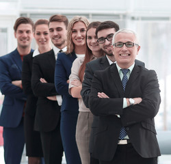 professional team confidently look forward, standing in the middle of the office