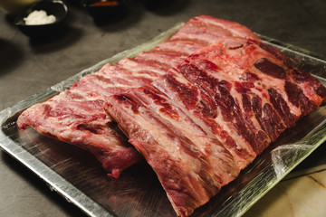 Raw pork ribs on steel plate