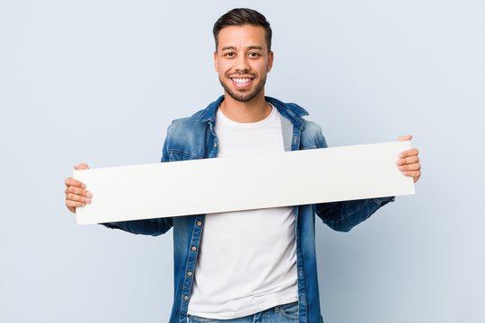 Young South-asian Man Holding A White Placard.