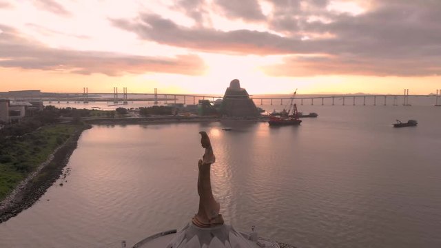 Aerial shot of Kun Iam statue and Macau Science Centre in front of stunning sunrise