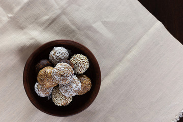 Energy protein balls on a dark wooden table. Healthy, nutritious and delicious snack. Flat lay.