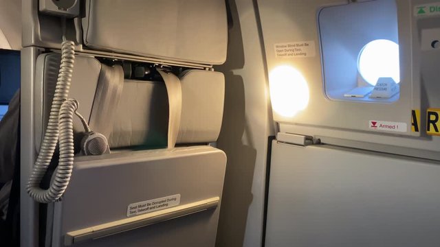 Light and shadows dancing on a airplane emergency exit