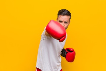 Young south-asian boxer man wearing red gloves.