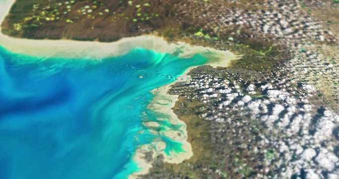 Very high-altitude circular tracking shot of rocky coastland, southwest Baffin Island, Canada, with tilt-shift effect. Reversible, seamless loop. Elements of this image furnished by NASA