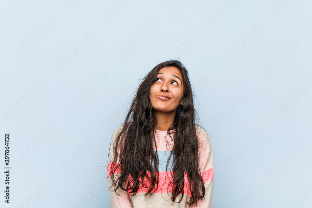 Wall mural Young fashion indian woman dreaming of achieving goals and purposes