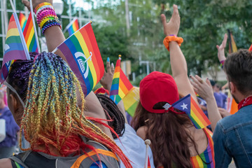 Orlando, Florida. October 12, 2019. Colorful womans with rainbow flags in Come Out With Pride...