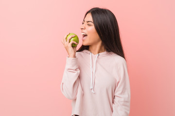 young arab woman eating an apple