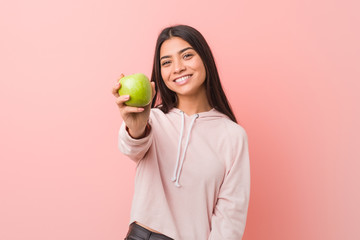 young arab woman eating an apple