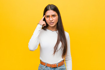 Young pretty arab woman against a yellow background showing a disappointment gesture with...