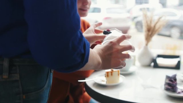 Waitress is carring desserts to the table