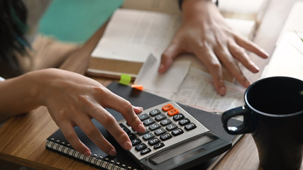Fototapeta na wymiar Home finance concept, Close-up woman calculating paying utility bills.