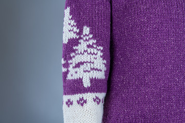Close up of christmas sweater on gray background