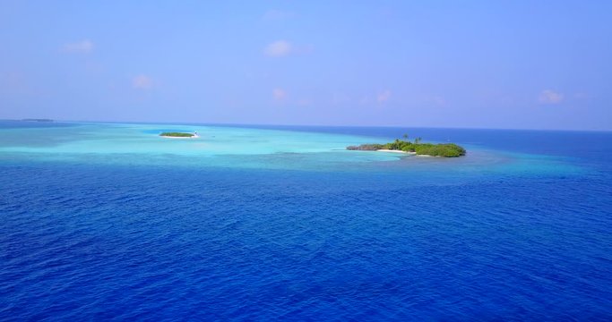 Vast blue and turquoise ovean surround two tiny islands in Thailand