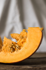 Fresh pumpkin on the table from old boards. Vertical orientation and white background.