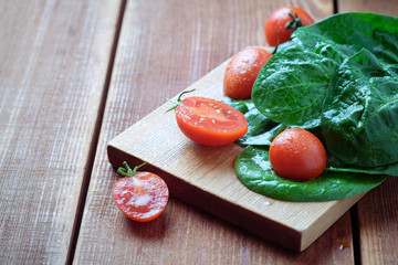 summer salad with tomatoes in white plate on wood table