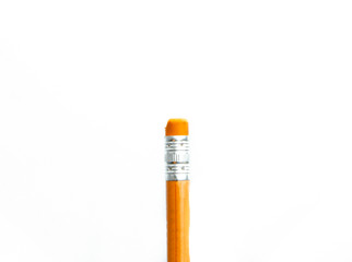 Orange pencil with an eraser on a white background close-up