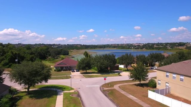 4k drone footage flying through the ​neighborhood towards a lake in Clermont, Florida