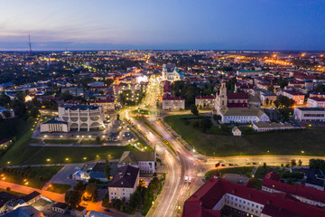 The embankment, the Neman river and the Old bridge in Grodno. Autumn ,evening, the city in the sunshine against a background of dark clouds