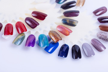 Palette of nail polish for manicure on white background