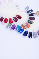 Palette of nail polish for manicure on white background