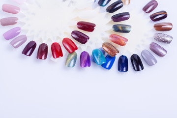 Palette of nail polish for manicure on white background