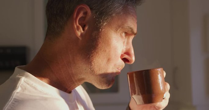 Man drinking coffee at home