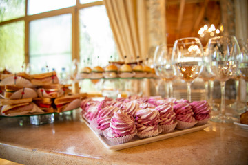 banquet table with food and drinks indoors