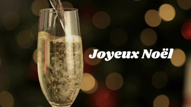 Joyeux NoÃ«l written over champagne flute