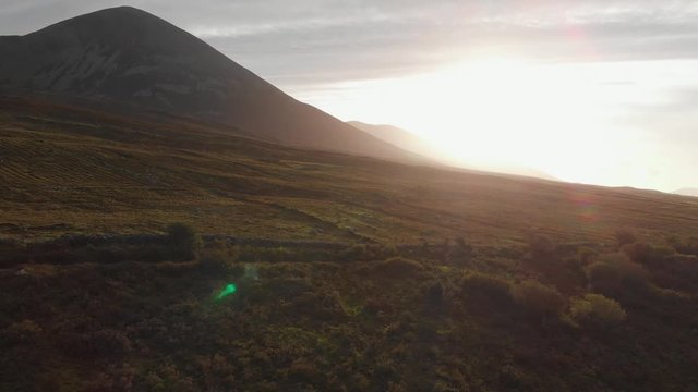 Aerial: Sunshine on Croagh Patrick mountain above irish landscape