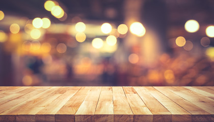 Wood texture table top (counter bar) with blur light gold bokeh in cafe,restaurant background