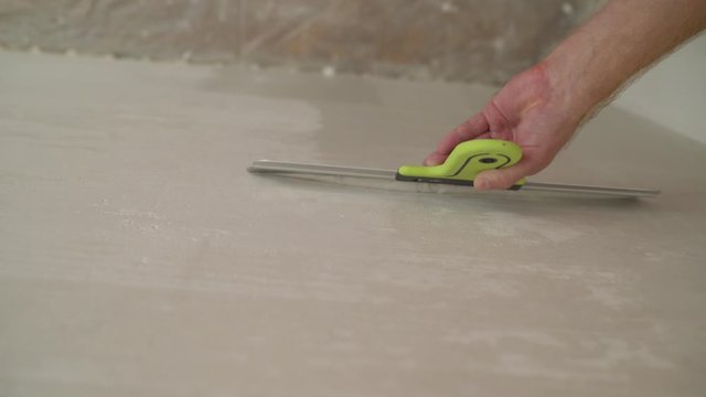 Hand with putty knife repair wall, Hand with a spatula, spatula with spackle paste structure, process of applying layer of putty trowel, working with spackling paste