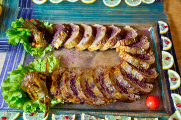 Grilled salmon fish and various vegetables on wooden table . chopped, baked live fish . Cooked baked grilled fish .
