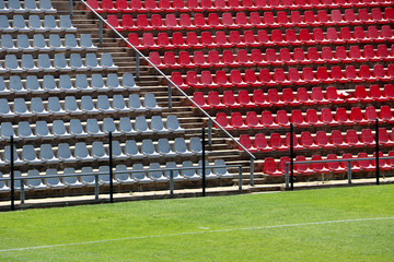 Empty red and grey seating at the Rand soccer football Stadium, Soweto, South Africa, for opposition, two competing teams