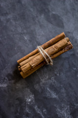Close up of cinnamon sticks tied with cord