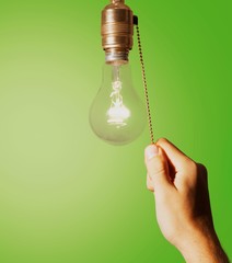 Hand turning off the bulb lamp.Turning off the light.