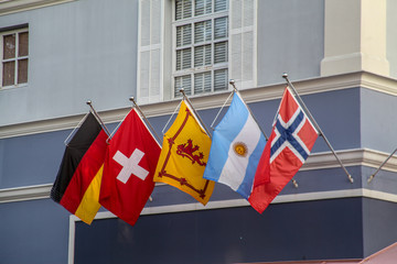 Flags of five countries floating in the wind, in a building in Orlando, from left to right: Germany, Switzerland, Scotland, Argentina and Norway.