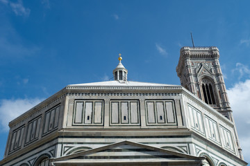 Florence's Santa Maria del Fiore Baptistery with Giotto's tower and blue sky.