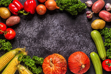 Fresh autumn vegetables for cooking on a dark background.