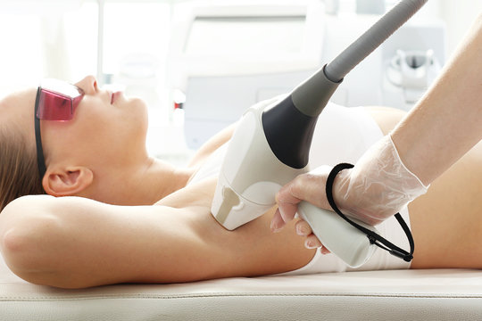 Laser hair removal, armpit hair removal. Woman in a laser hair removal salon