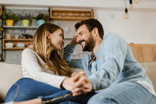 Loving happy couple talking to each other at home