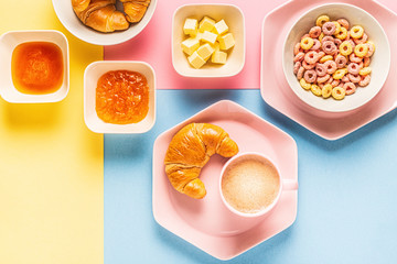 Coffee and croissants on a bright trendy background